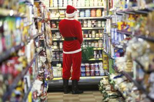 Man dressed as Santa Claus standing in supermarket, rear view